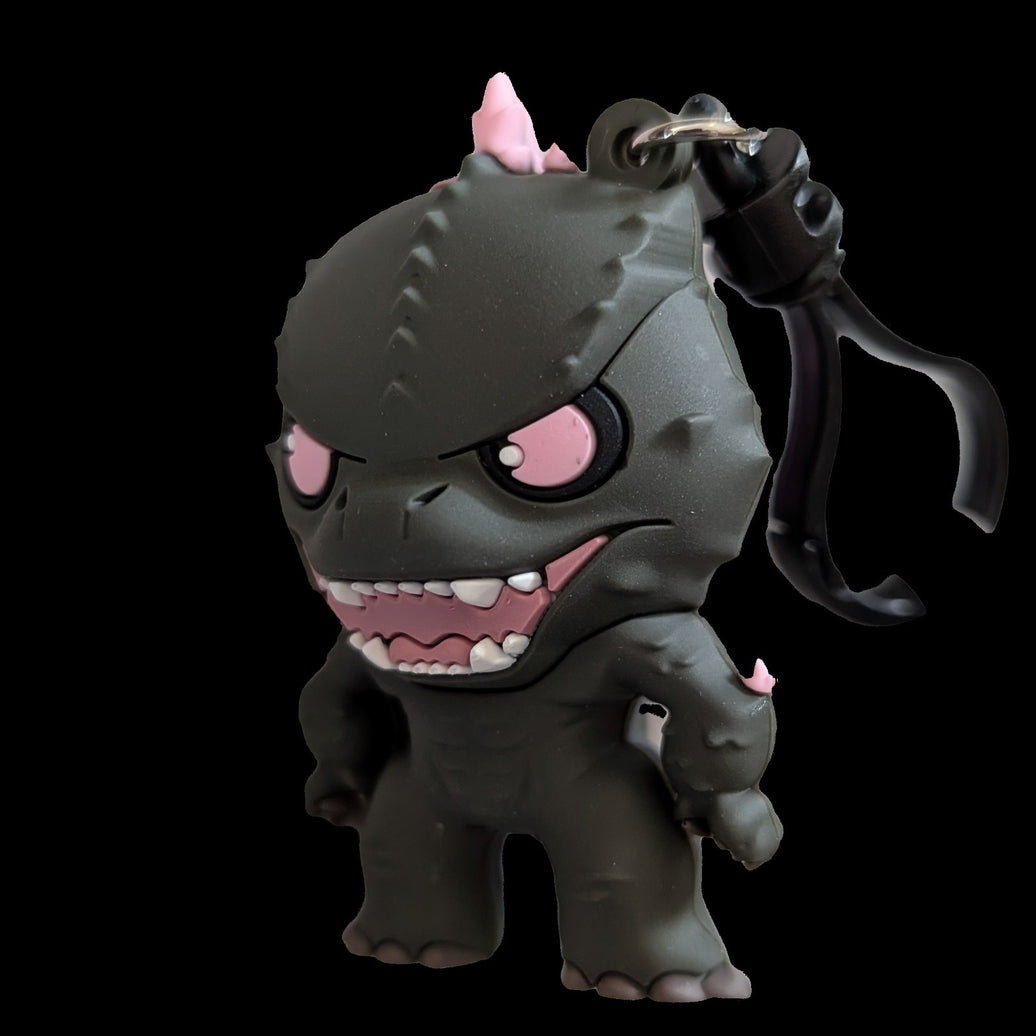 Monogram Evolved Godzilla 3D foam bag clip keychain with detailed black design and pink accents on black background.