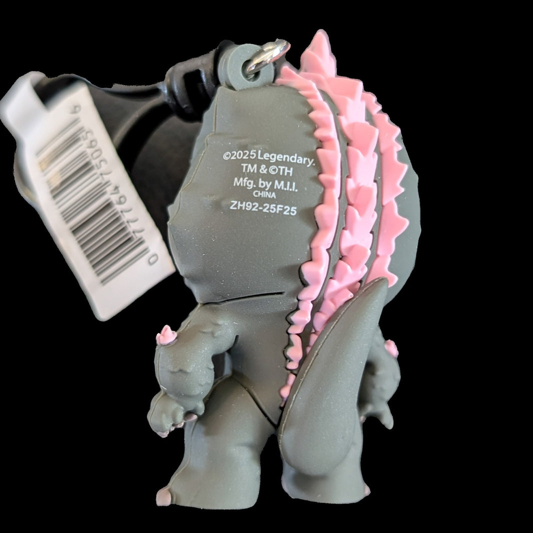 Back view of Monogram Evolved Godzilla 3D foam bag clip keychain with detailed pink dorsal plates and tag attached