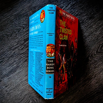 Vintage 1969 edition of The Twisted Claw Hardy Boys book with distinctive blue and red cover by Grosset & Dunlap