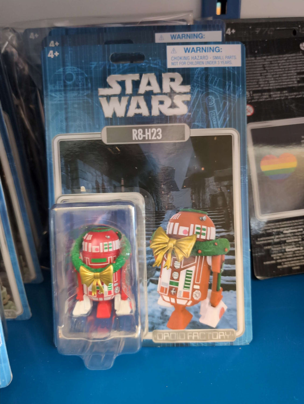 R8-H23 Star Wars Droid Factory Christmas action figure with wreath and bow, collectible by Disney.