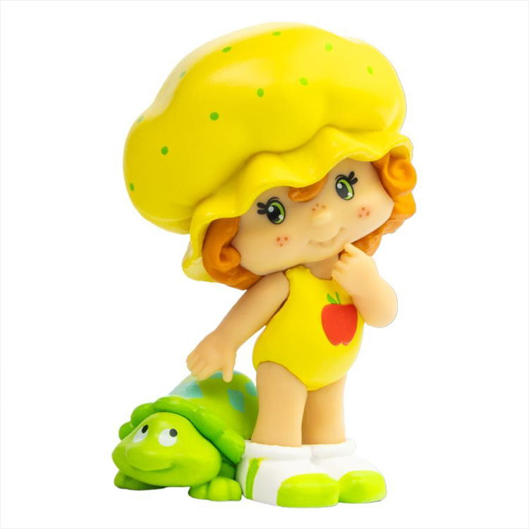 Loyal Subjects Strawberry Shortcake Cheebee figure in yellow outfit with turtle collectible toy on white background
