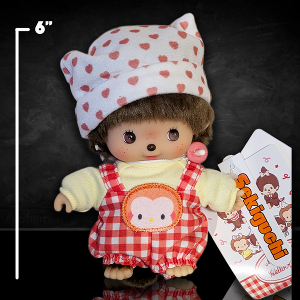 Sekiguchi 6-inch Monchhichi Bebichhichi plush in Hello Kitty-inspired outfit with pink heart hat and pacifier