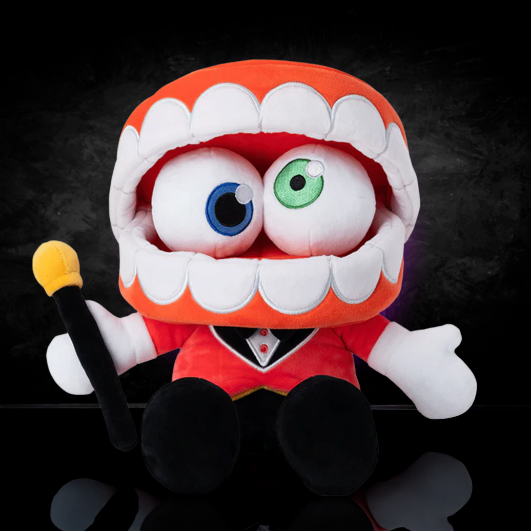 Glitch Caine plush from The Amazing Digital Circus with large open mouth, heterochromatic eyes, red jacket, and black bowtie sitting on black background