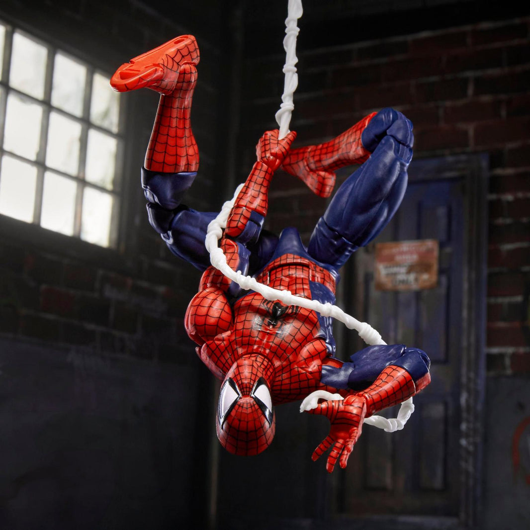 Hasbro Marvel Legends Spiderman 6-inch action figure posed hanging upside down on web line in dark room setting