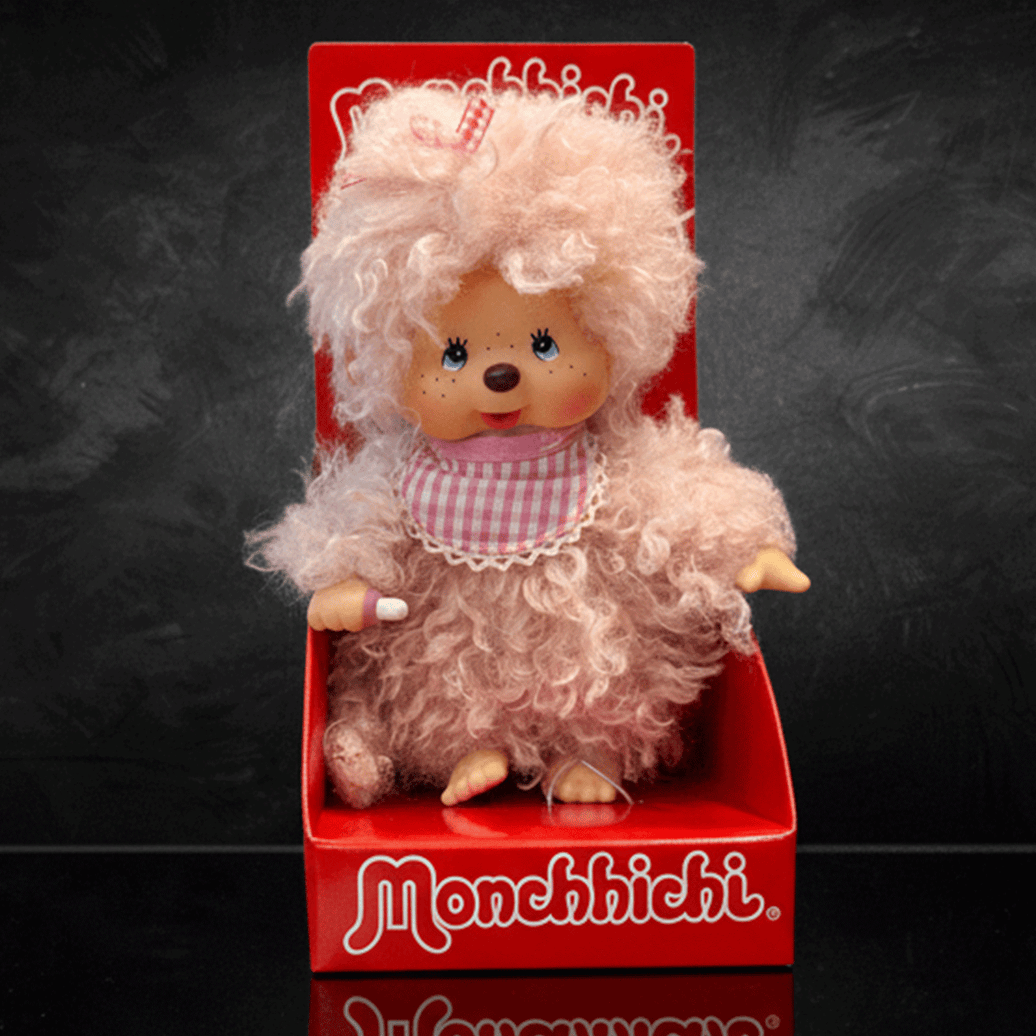 Sekiguchi 8 inch Monchhichi girl doll with fluffy pink beige fur wearing pink gingham bib in red box
