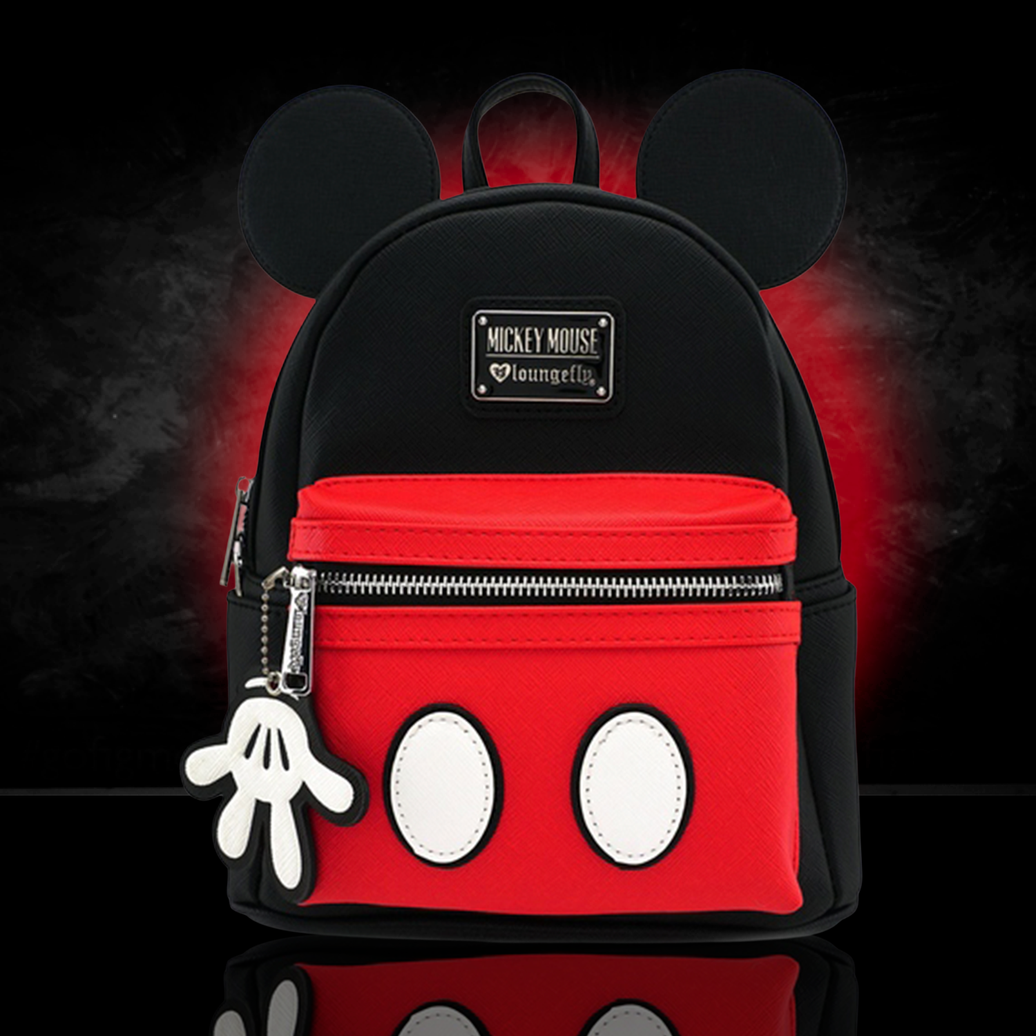 Loungefly Mickey Mouse mini backpack with black ears, red front pocket, white buttons, and glove zipper charm on black background