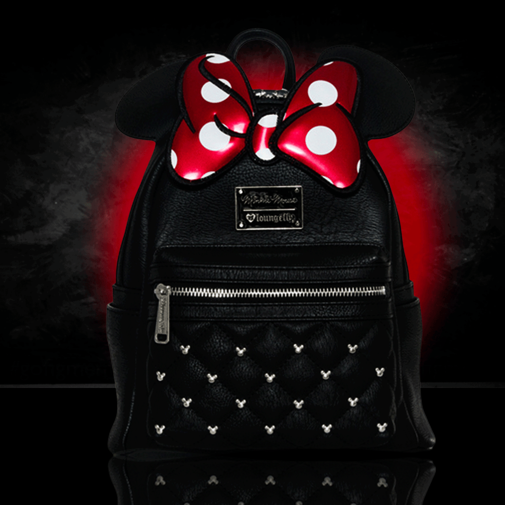 Loungefly mini backpack with quilted black body, silver studs, large red polka dot bow, and 3D Minnie Mouse ears