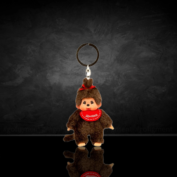 Sekiguchi Monchhichi 4-inch classic girl plush keychain with red bib and bow on black background