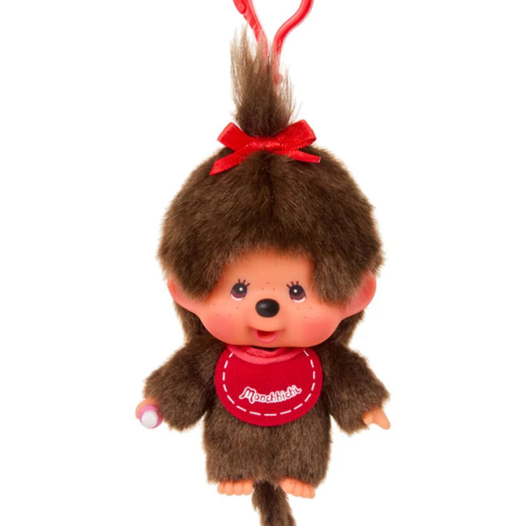 Sekiguchi Monchhichi Girl plush keychain with brown fur, red bow, and signature pink bib, classic collectible design.