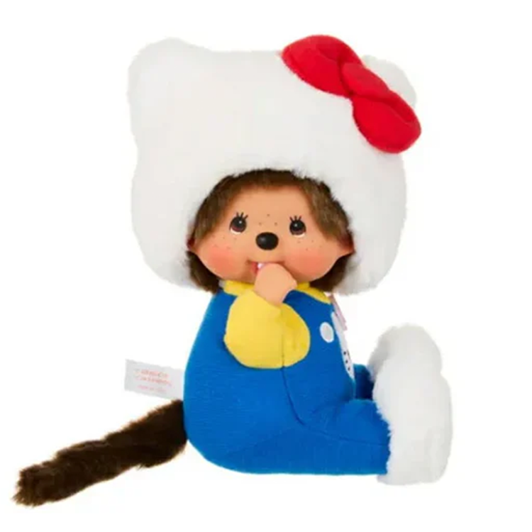 Sekiguchi plush doll of Monchhichi dressed as Hello Kitty with white hood, red bow, blue outfit, and sitting pose