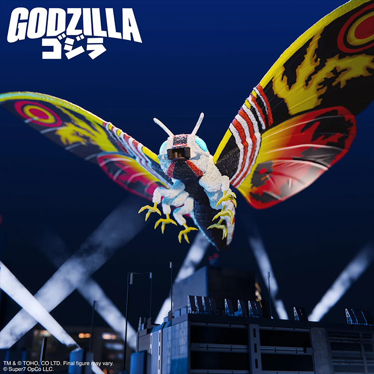 Super7 Mothra 1992 action figure with vibrant wings spread wide over cityscape at night against dark sky
