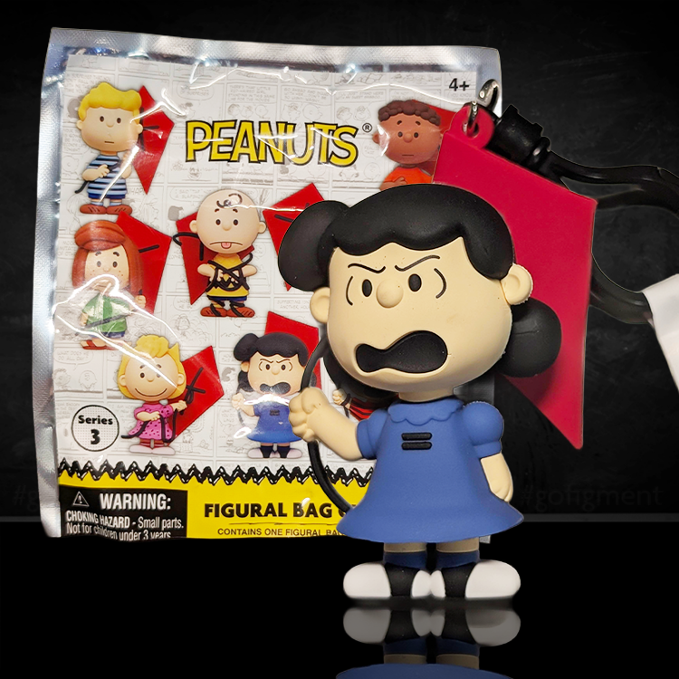 Lucy van Pelt 3D foam bag clip holding a red kite with angry scowl from Peanuts 75th Anniversary by Monogram