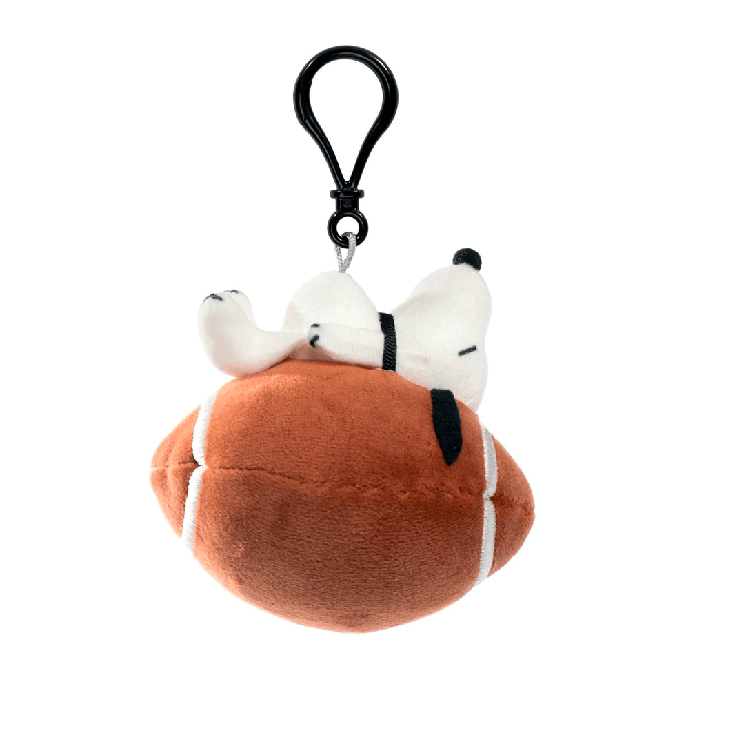 Peanuts Snoopy plush keychain bag clip resting on a football by Go Figment with black clip attachment