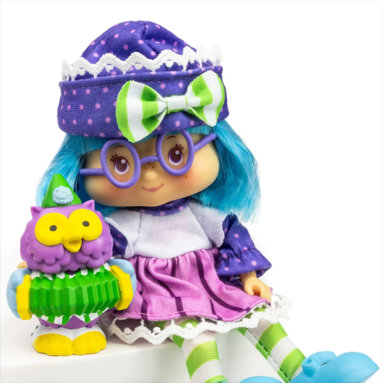 Loyal Subjects Strawberry Shortcake Plum Pudding collectible doll with blue hair, purple outfit, and owl accessory in white background.