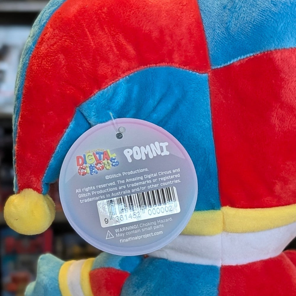 Close up of Glitch Pomni plush tag on colorful 11 inch soft toy from The Amazing Digital Circus