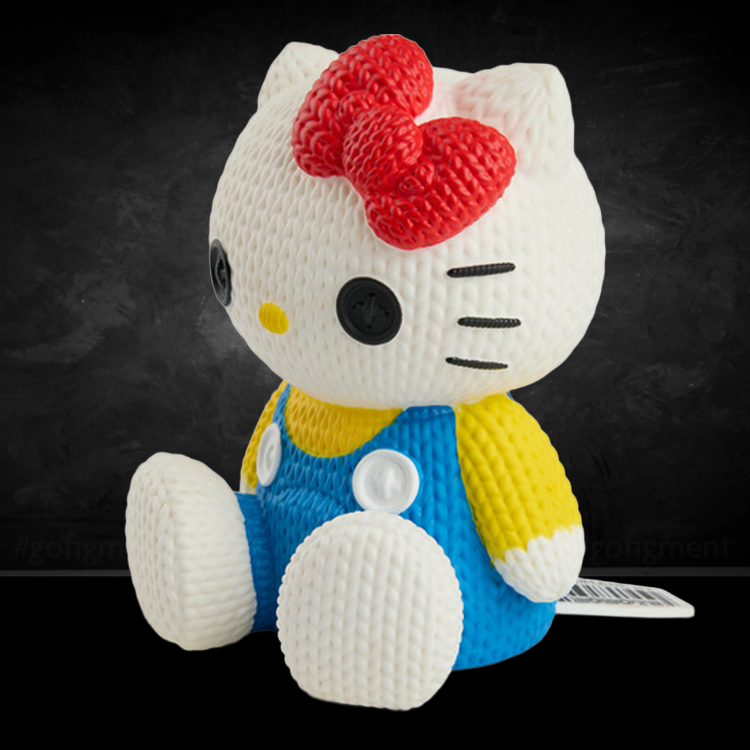 Handmade by Robots Hello Kitty vinyl figure in knit-inspired texture wearing blue overalls and red bow sitting on black background