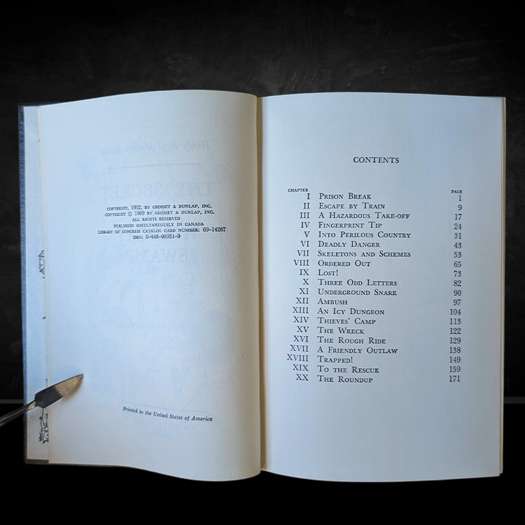 Open vintage book showing the copyright and detailed contents page of the Hardy Boys mystery number 31, printed by Grosset & Dunlap