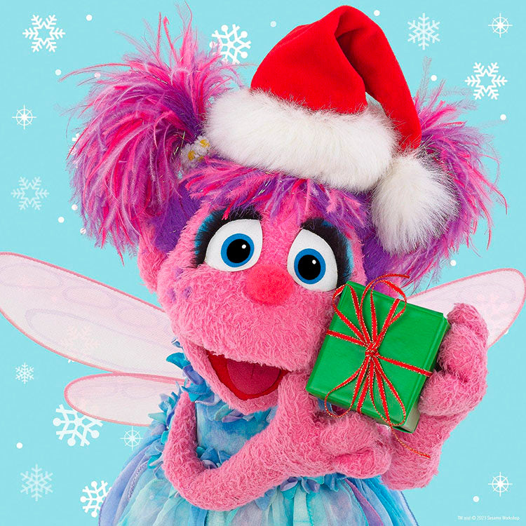 Master Pieces Sesame Street Abby Cadabby plush character wearing Santa hat holding green gift with snowflakes background