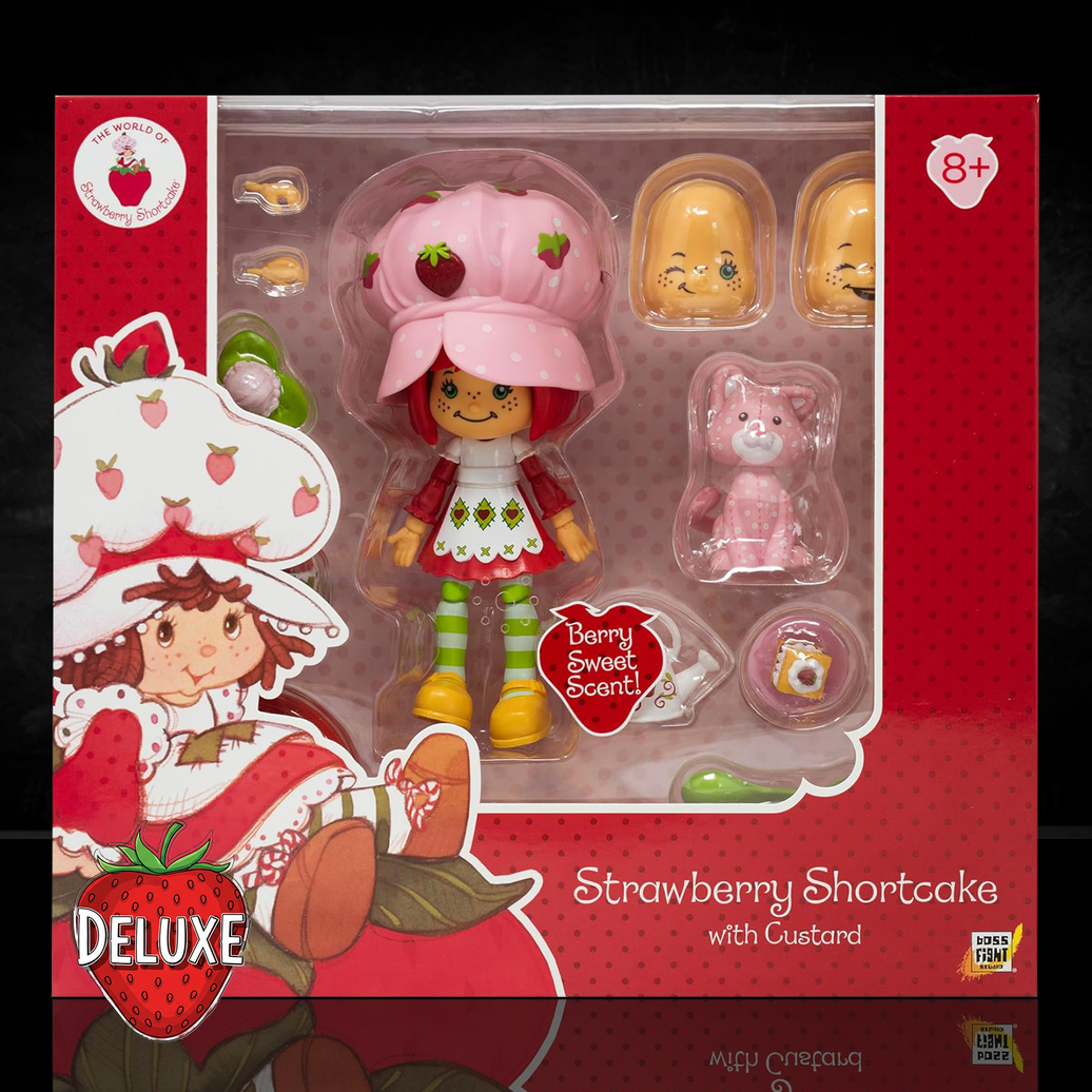 Boss Fight Studio Llc Strawberry Shortcake deluxe figure with pink hat, green striped stockings, custard kitten, and accessory pieces in packaging