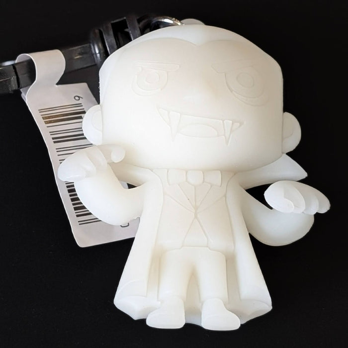 Go Figment Universal Monsters Series 4 white Dracula figural bag clip with attached keyring and barcode tag on black background