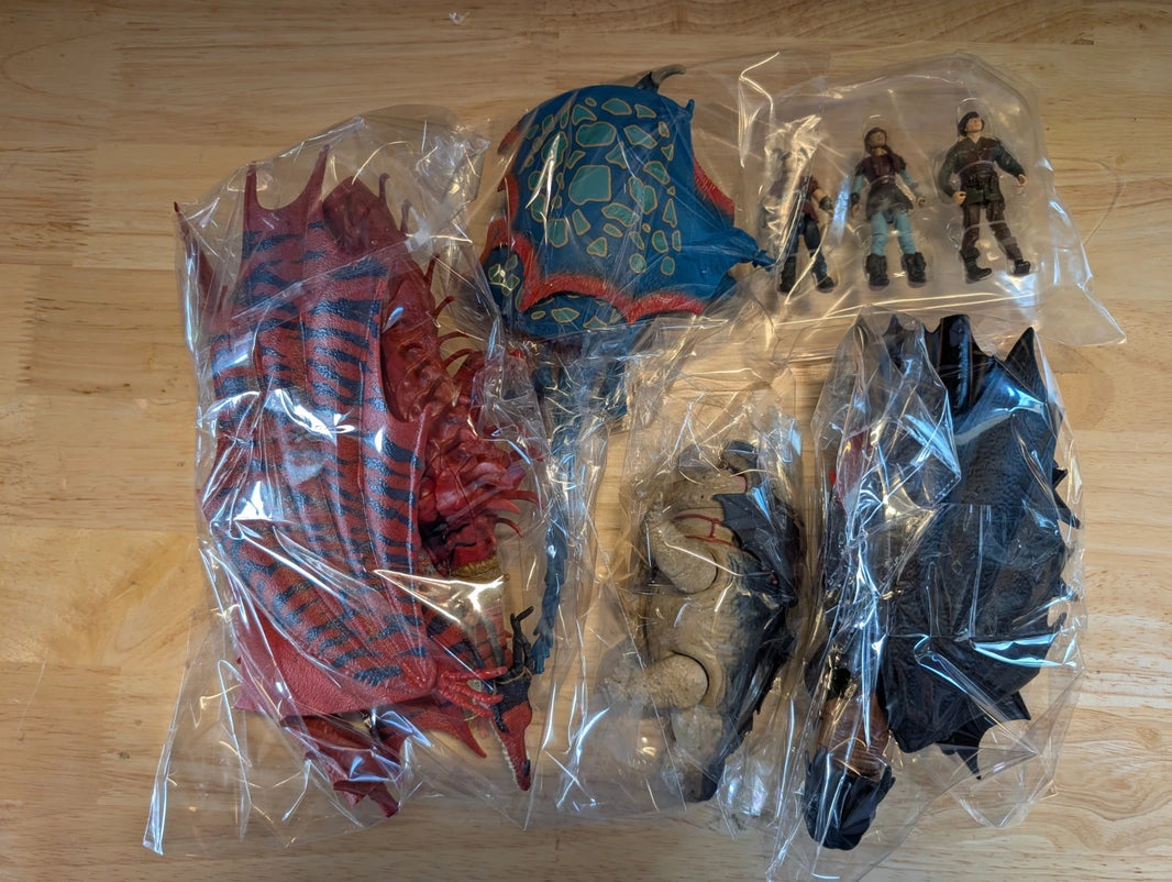Unboxed How to Train Your Dragon Final Battle 4 Figure Set with detailed dragons and Viking riders in plastic packaging
