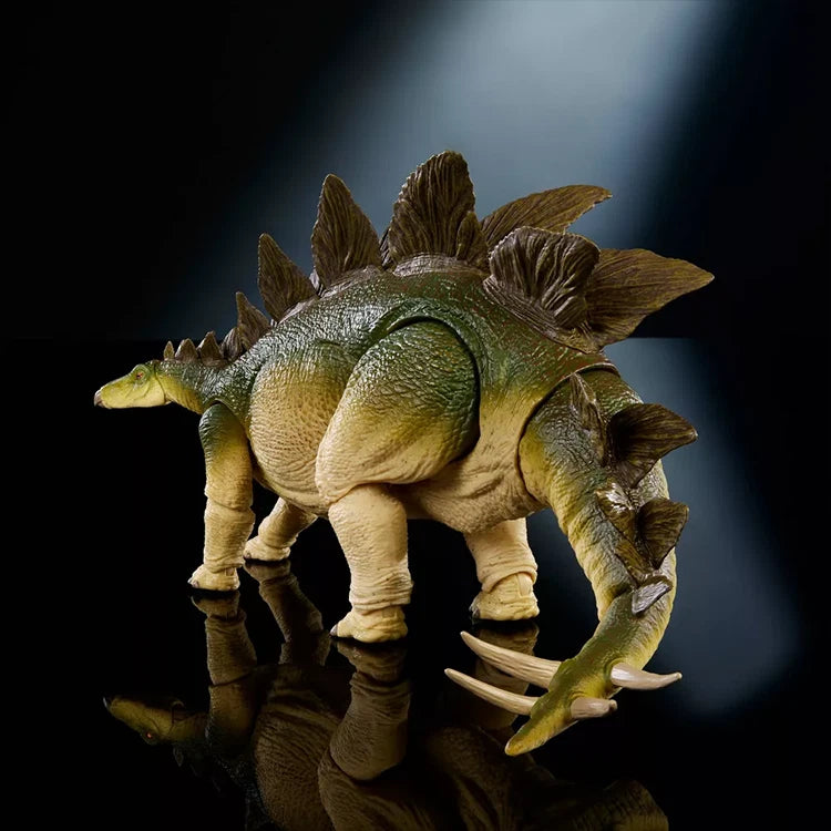 Mattel Jurassic World Hammond Collection Stegosaurus figure with detailed plates and posable tail in dramatic lighting.