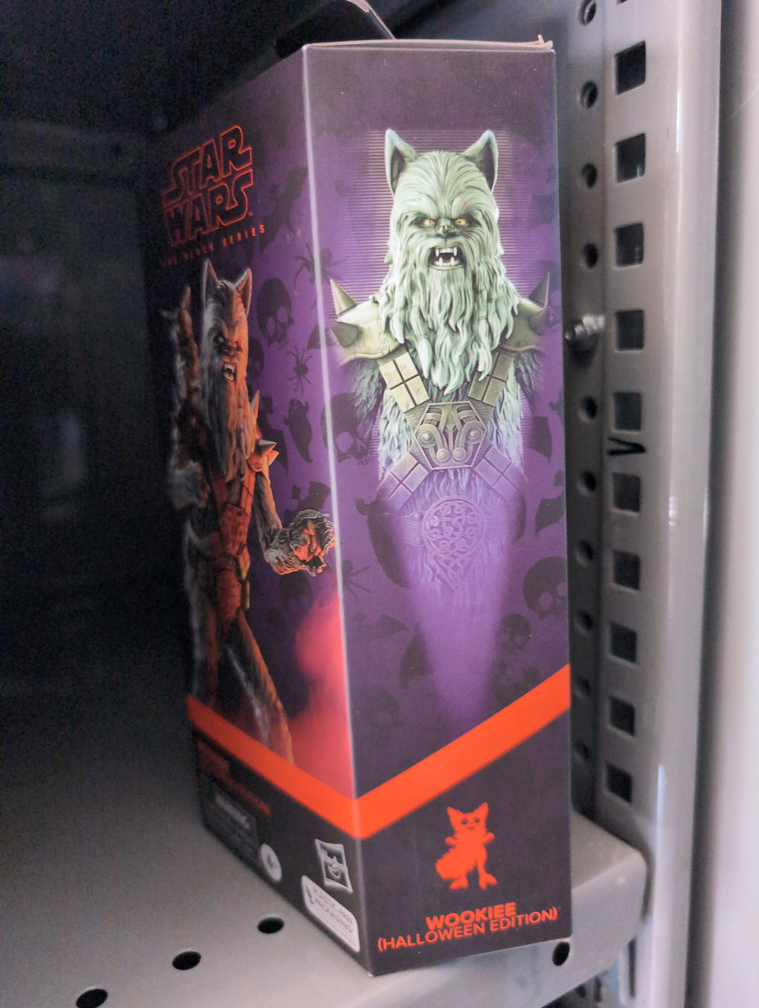 Hasbro Star Wars Black Series Halloween Wookiee action figure packaging with spooky purple design on shelf