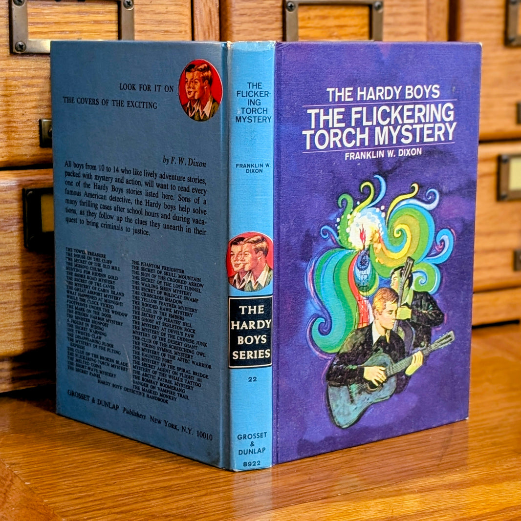 Vintage 1971 Hardy Boys book The Flickering Torch Mystery by Grosset & Dunlap with blue back cover and colorful illustration