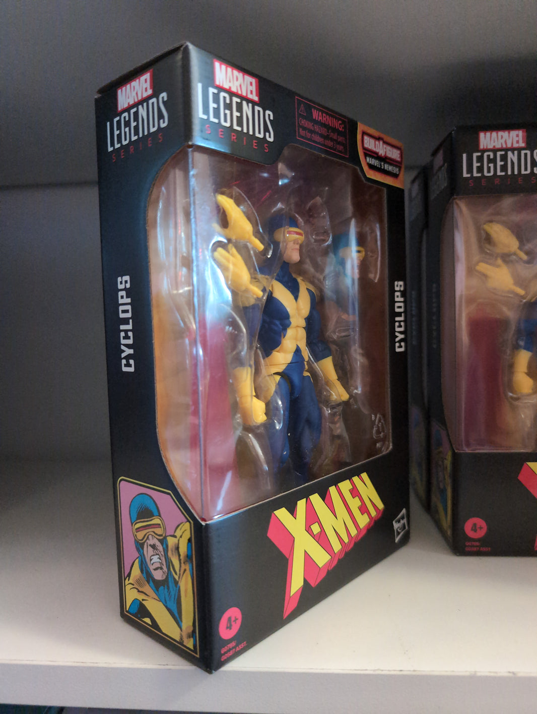 Hasbro Marvel Legends Cyclops 6-inch action figure from X-Men series in original packaging on display shelf