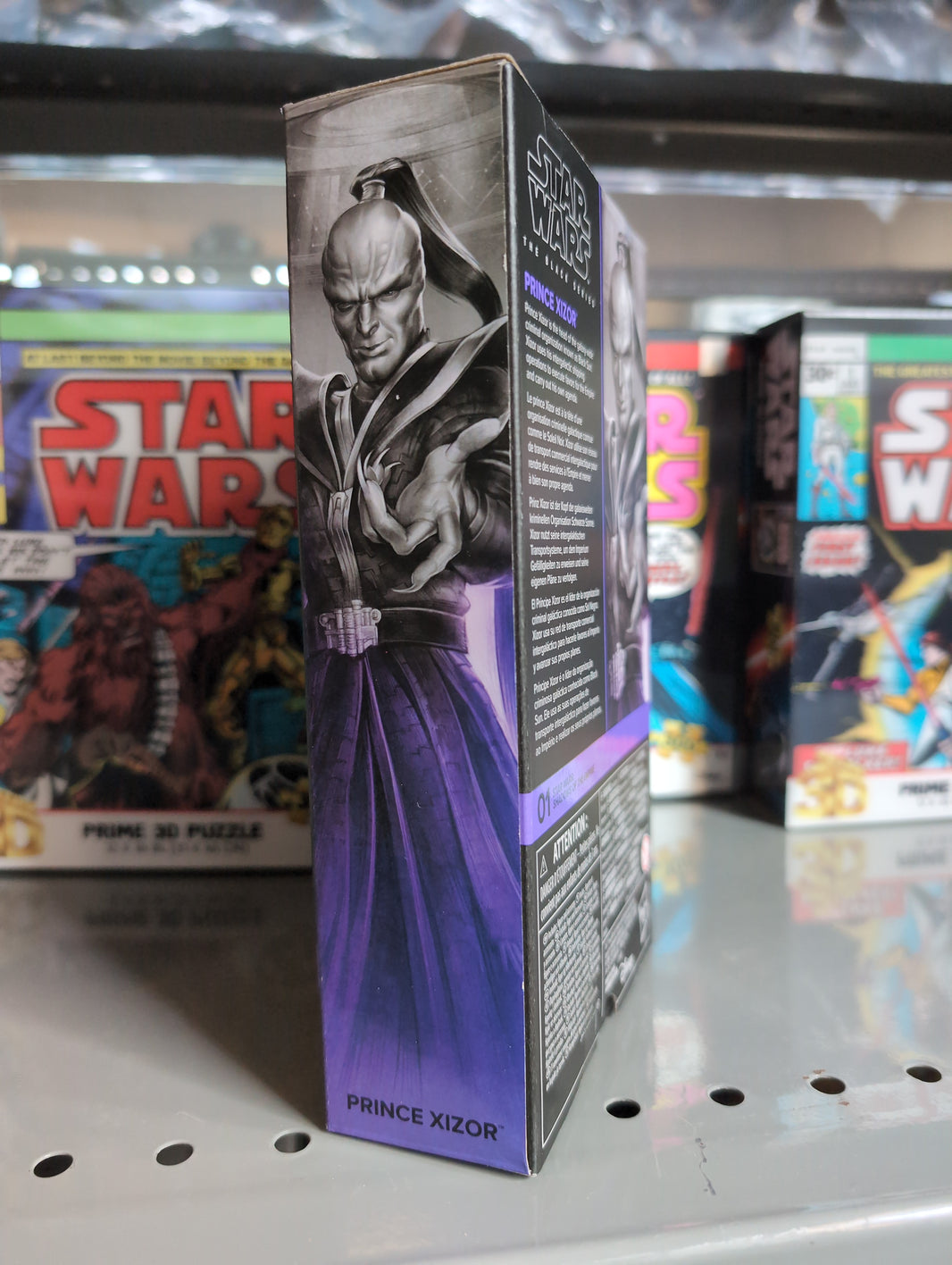 Hasbro Star Wars Black Series Prince Xizor action figure box with character art on display shelf