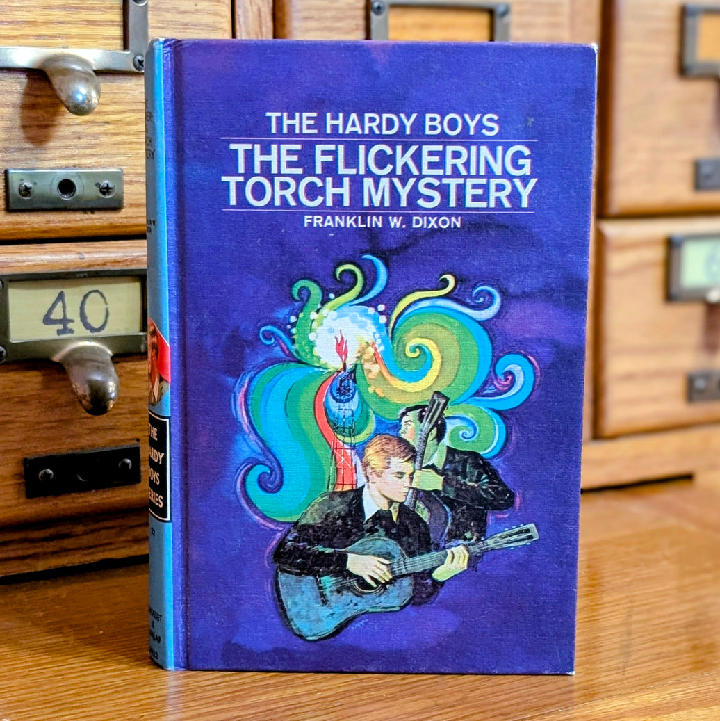Vintage 1971 Hardy Boys The Flickering Torch Mystery book by Grosset & Dunlap with colorful cover art and guitar player illustration