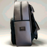 Side view of Loungefly full-size backpack in metallic finish with Godzilla logo patch and black straps visible
