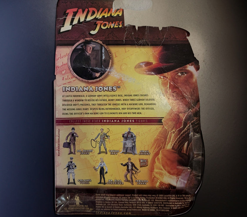 Hasbro Indiana Jones Last Crusade 2008 action figure packaging with character images and vintage movie art background