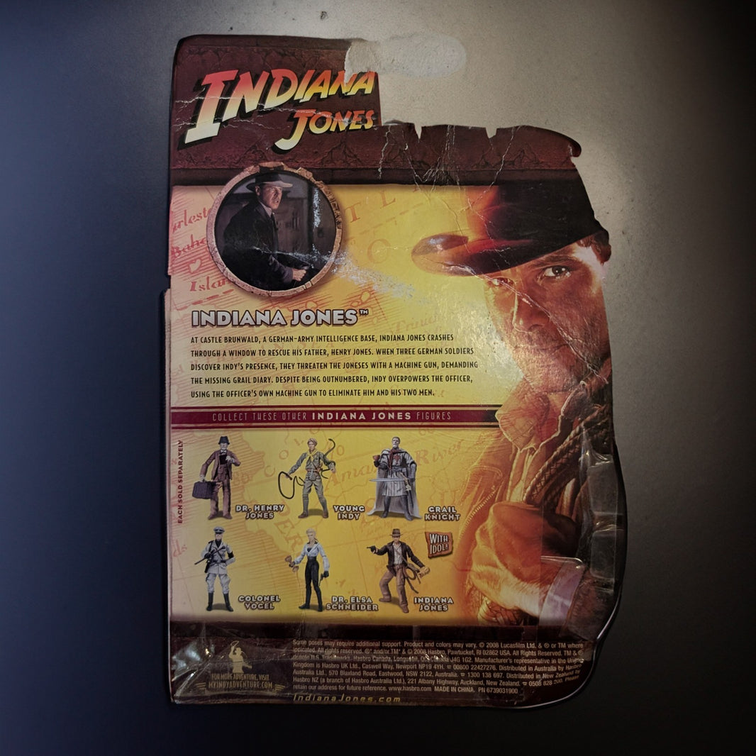 Hasbro Indiana Jones Last Crusade 2008 action figure packaging with character images and vintage movie art background