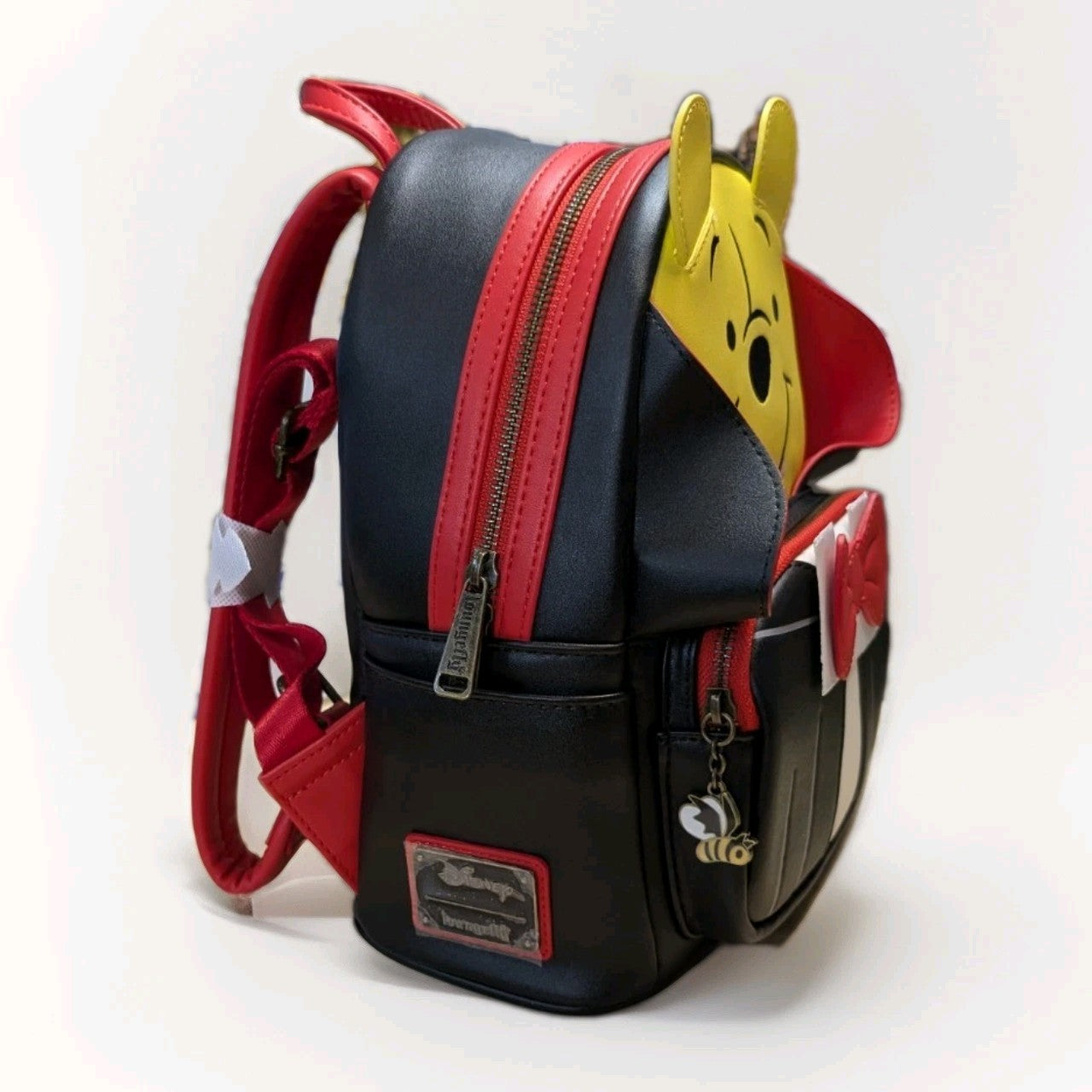 Loungefly mini backpack with Winnie the Pooh in vampire outfit, red accents, and bee charm on front pocket zipper