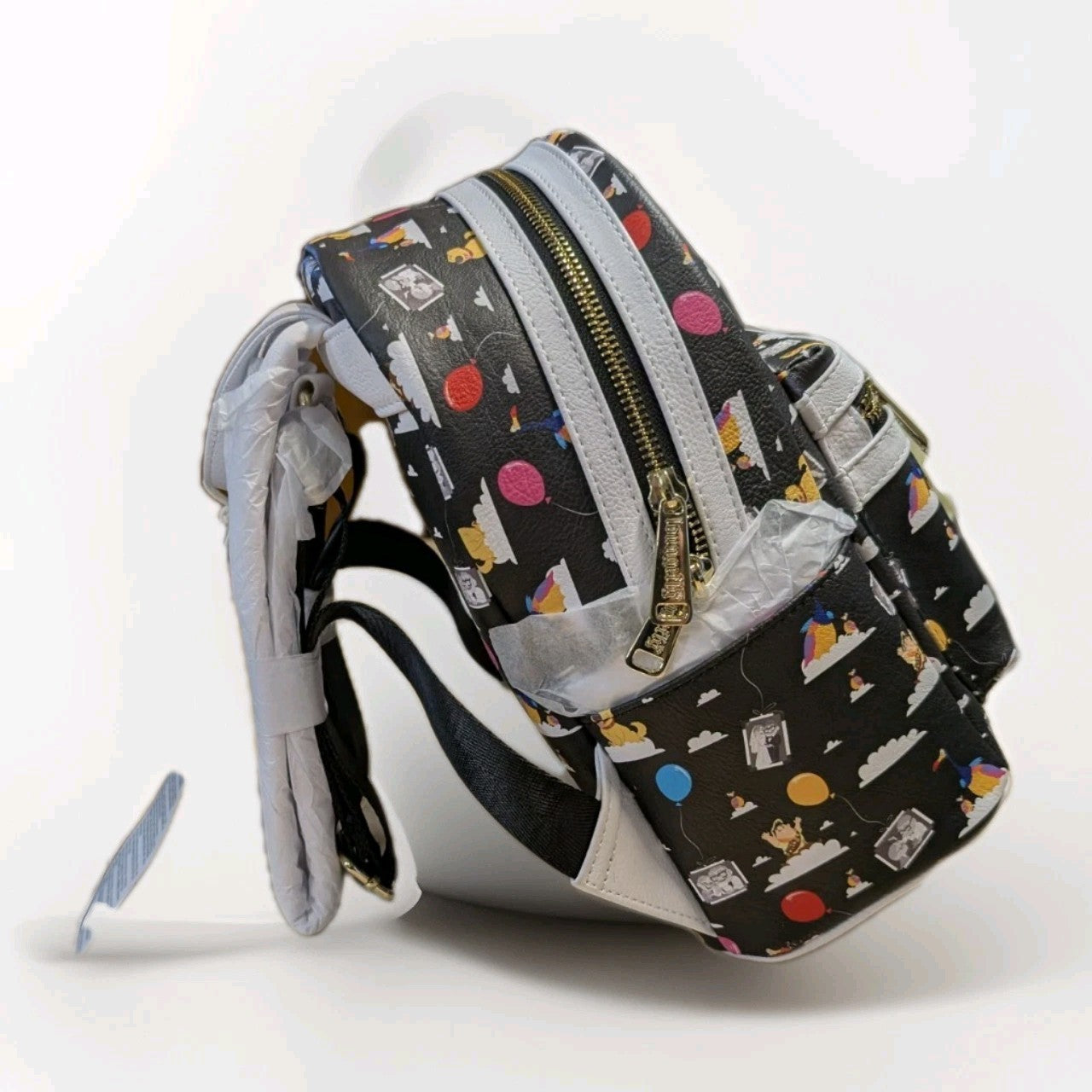 Loungefly black faux leather mini backpack featuring Pixar Up characters and colorful balloon pattern with gold zipper detail
