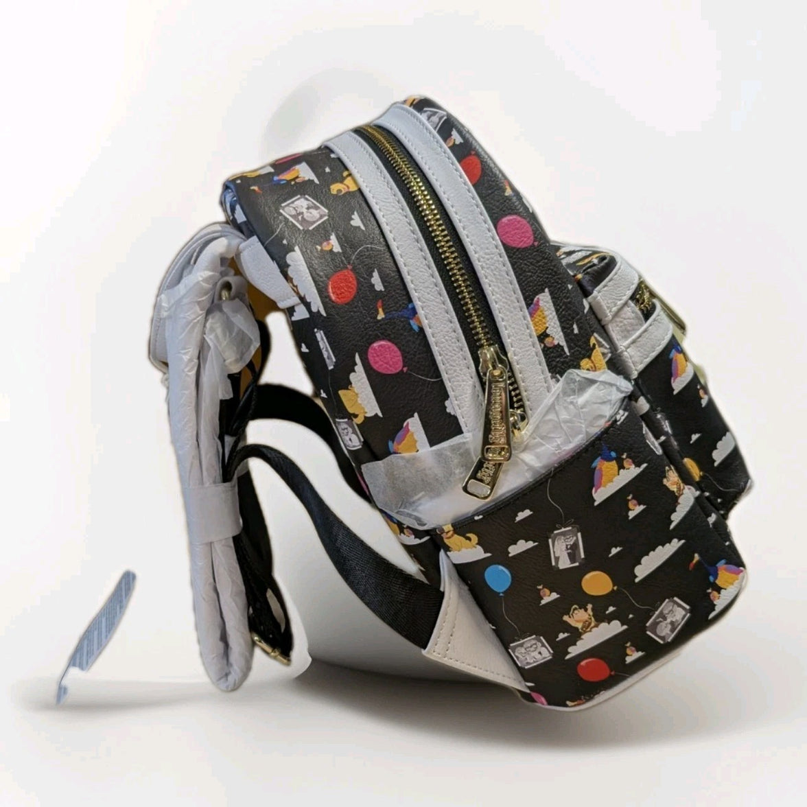 Loungefly black faux leather mini backpack featuring Pixar Up characters and colorful balloon pattern with gold zipper detail