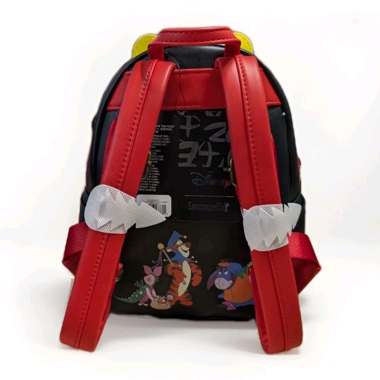 Loungefly mini backpack showing back straps and Halloween Pooh with Tigger, Piglet, and Eeyore characters design