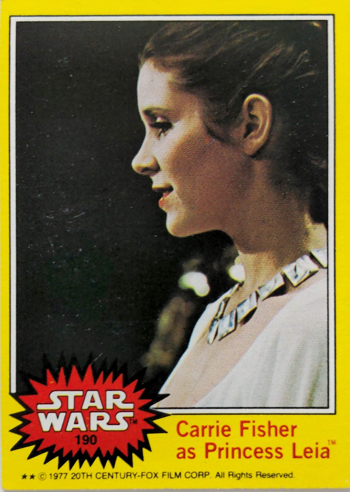 Vintage Star Wars trading card of Carrie Fisher as Princess Leia in profile with yellow border and logo