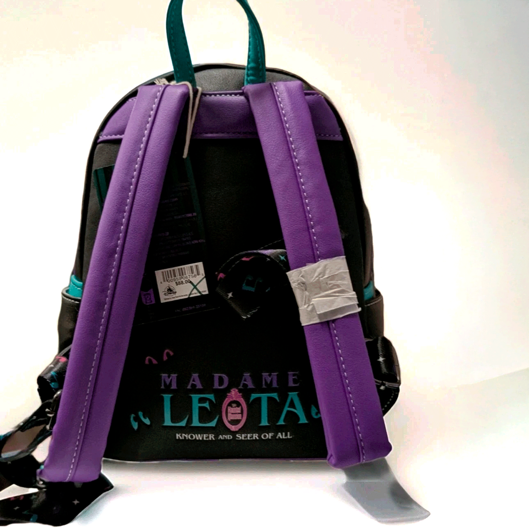 Loungefly mini backpack featuring Madame Leota theme with purple straps and teal accents on black background back view