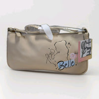 Danielle Nicole beige crossbody bag with Belle silhouette holding a rose and attached product tag visible