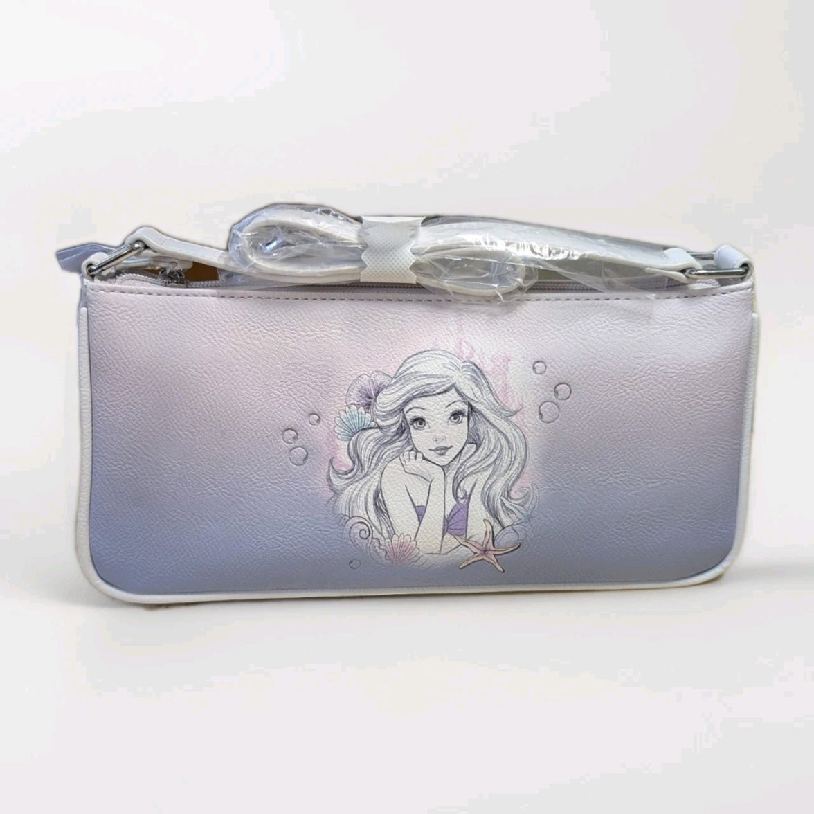 Danielle Nicole Little Mermaid baguette bag with watercolor Ariel illustration on soft purple gradient faux leather