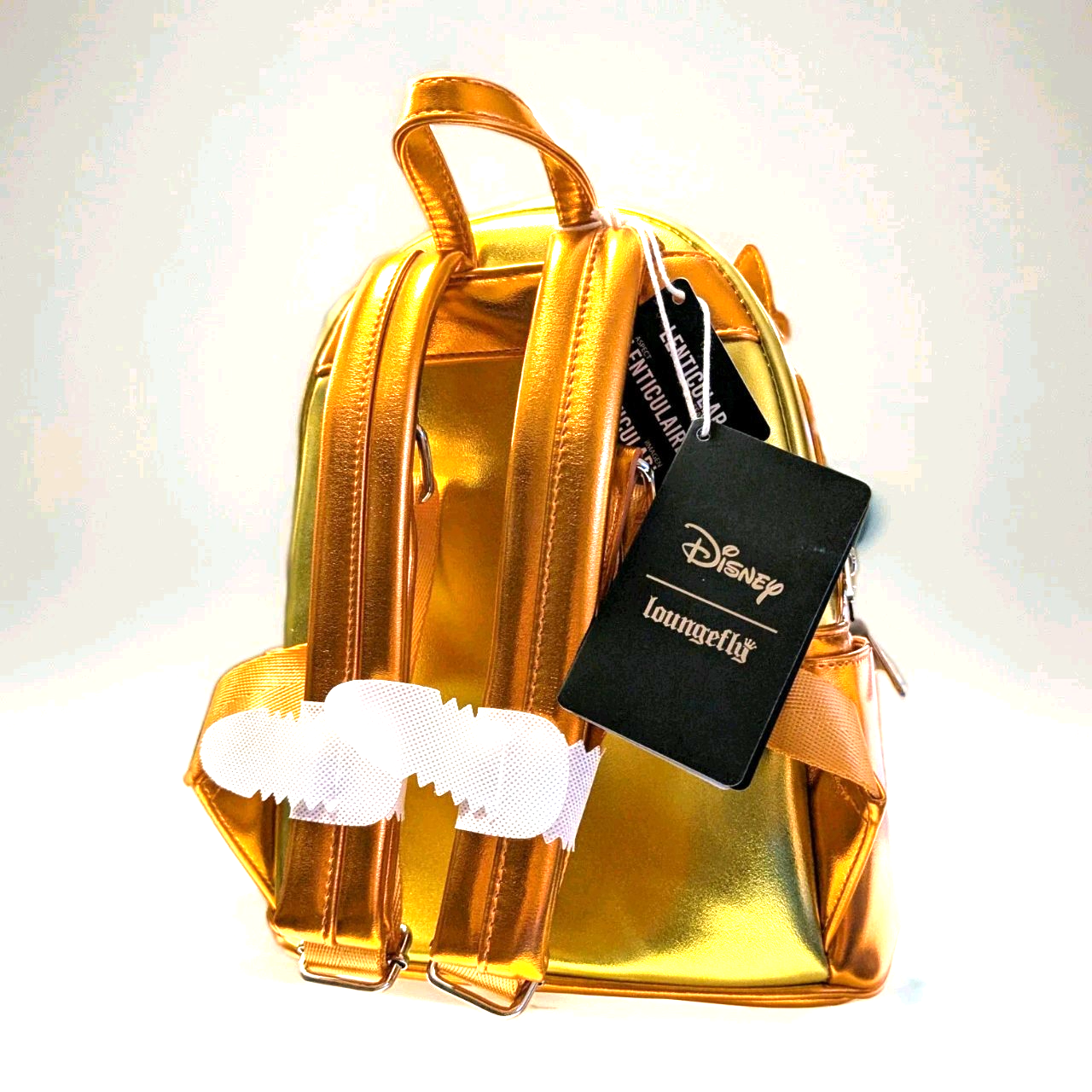 Loungefly metallic gold mini backpack showing back with adjustable straps and Disney branded tag attached