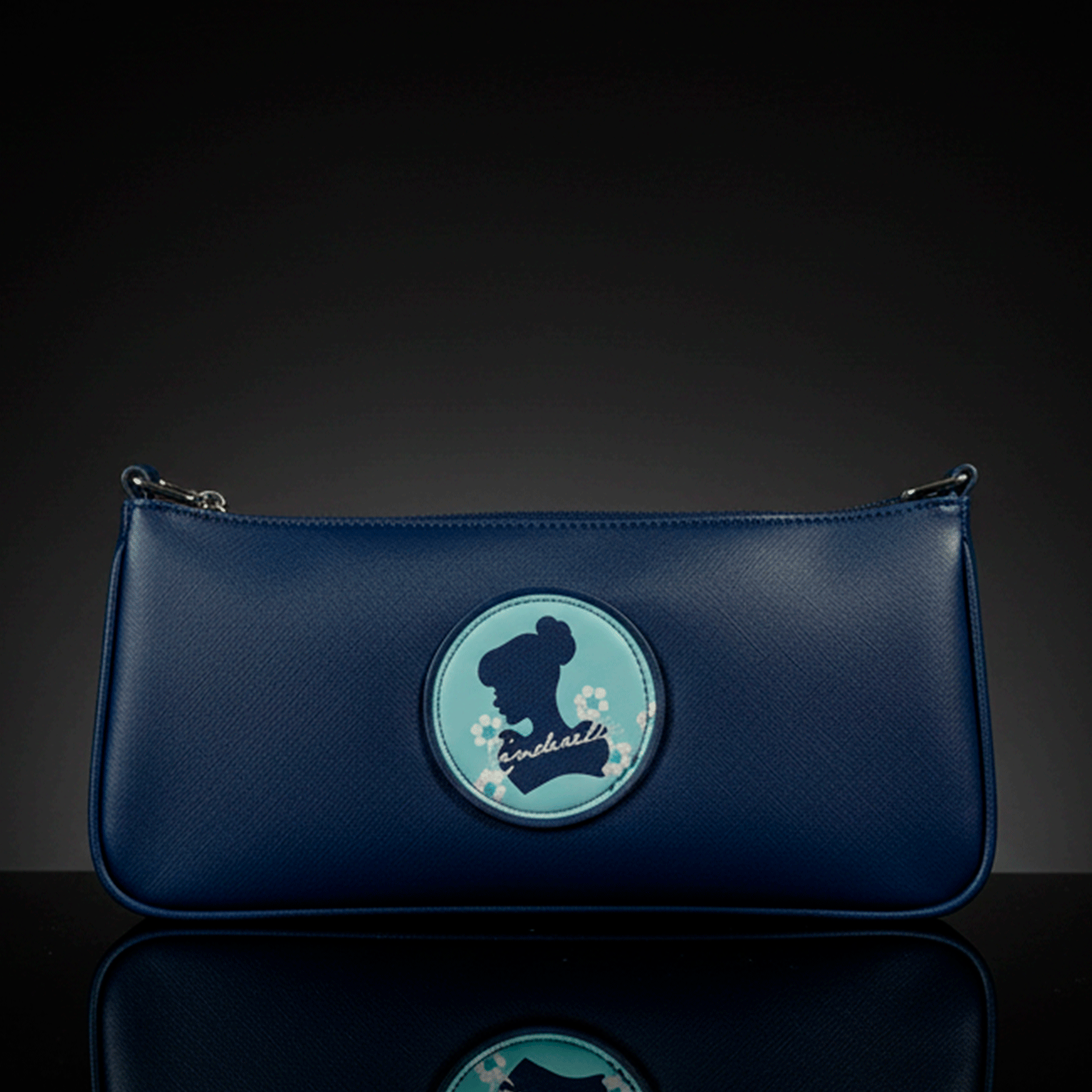 Danielle navy blue baguette bag with Cinderella silhouette and floral accents on round patch in center front