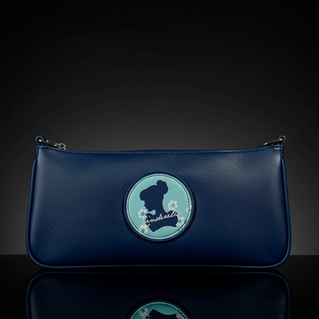 Danielle navy blue baguette bag with Cinderella silhouette and floral accents on round patch in center front