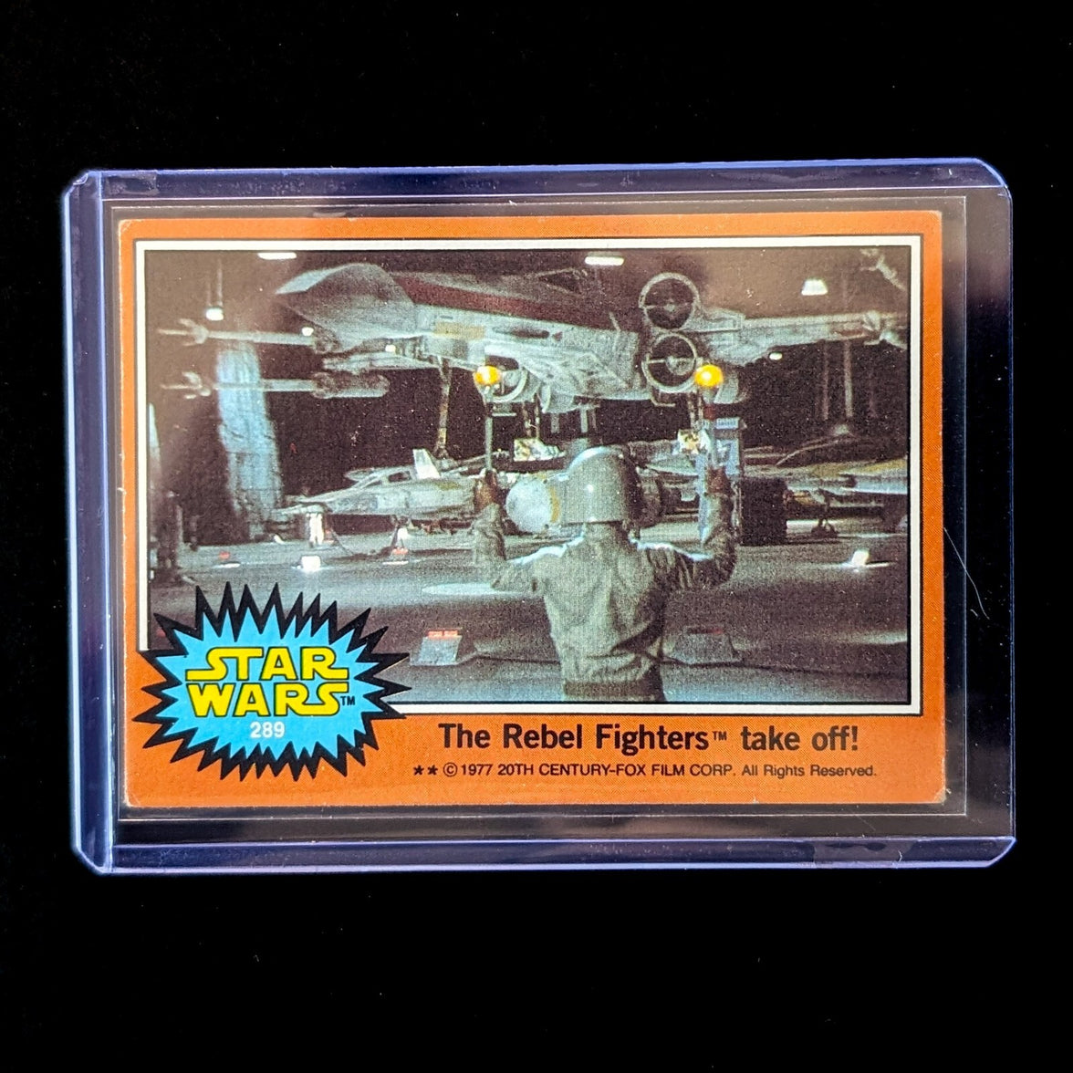 1977 Go Figment Star Wars trading card featuring Rebel Fighters preparing X-wing for takeoff in orange Series 4 border