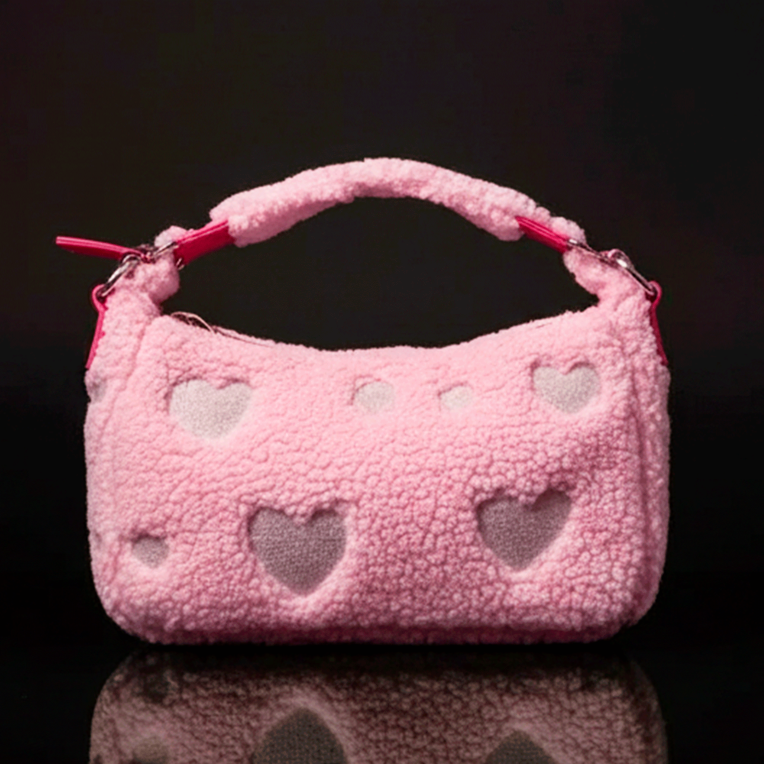 Loungefly pink sherpa crossbody bag with heart cutouts and plush handle against black background