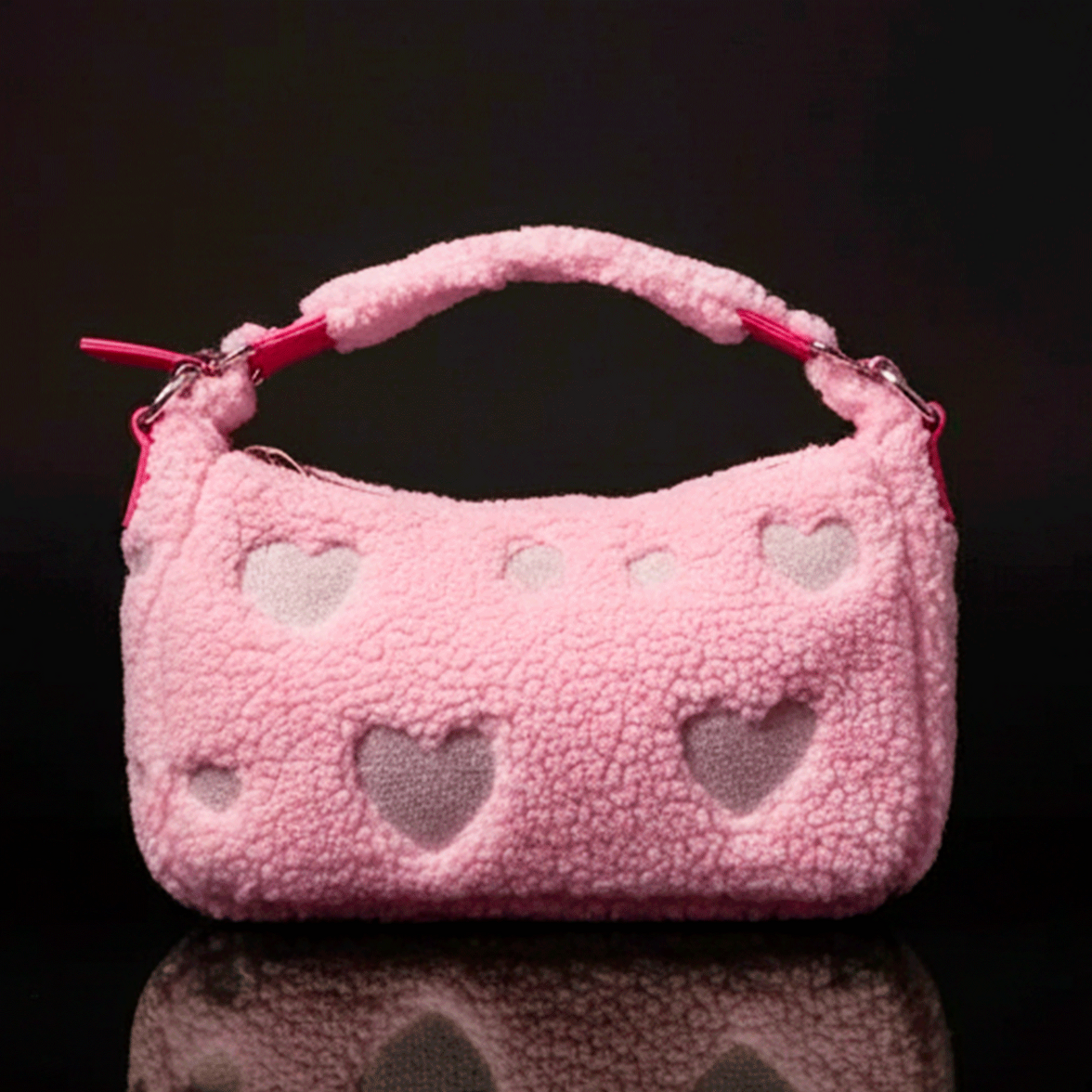 Loungefly pink sherpa crossbody bag with heart cutouts and plush handle against black background