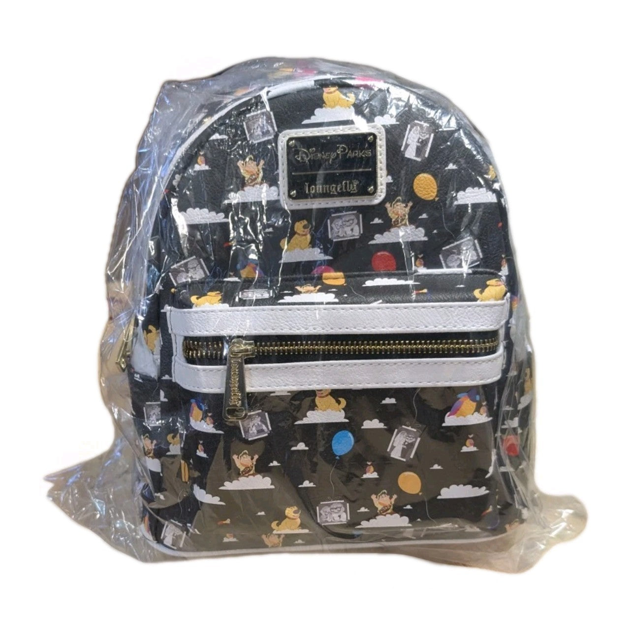 Loungefly black faux leather mini backpack with Winnie the Pooh pattern and colorful balloons wrapped in protective plastic packaging