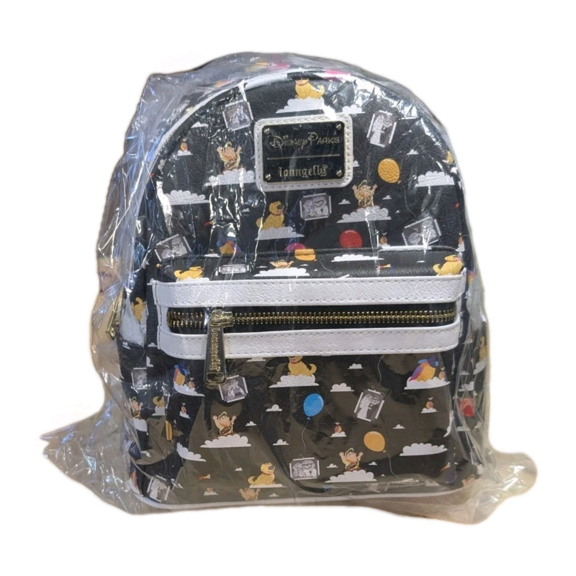 Loungefly black faux leather mini backpack with Winnie the Pooh pattern and colorful balloons wrapped in protective plastic packaging